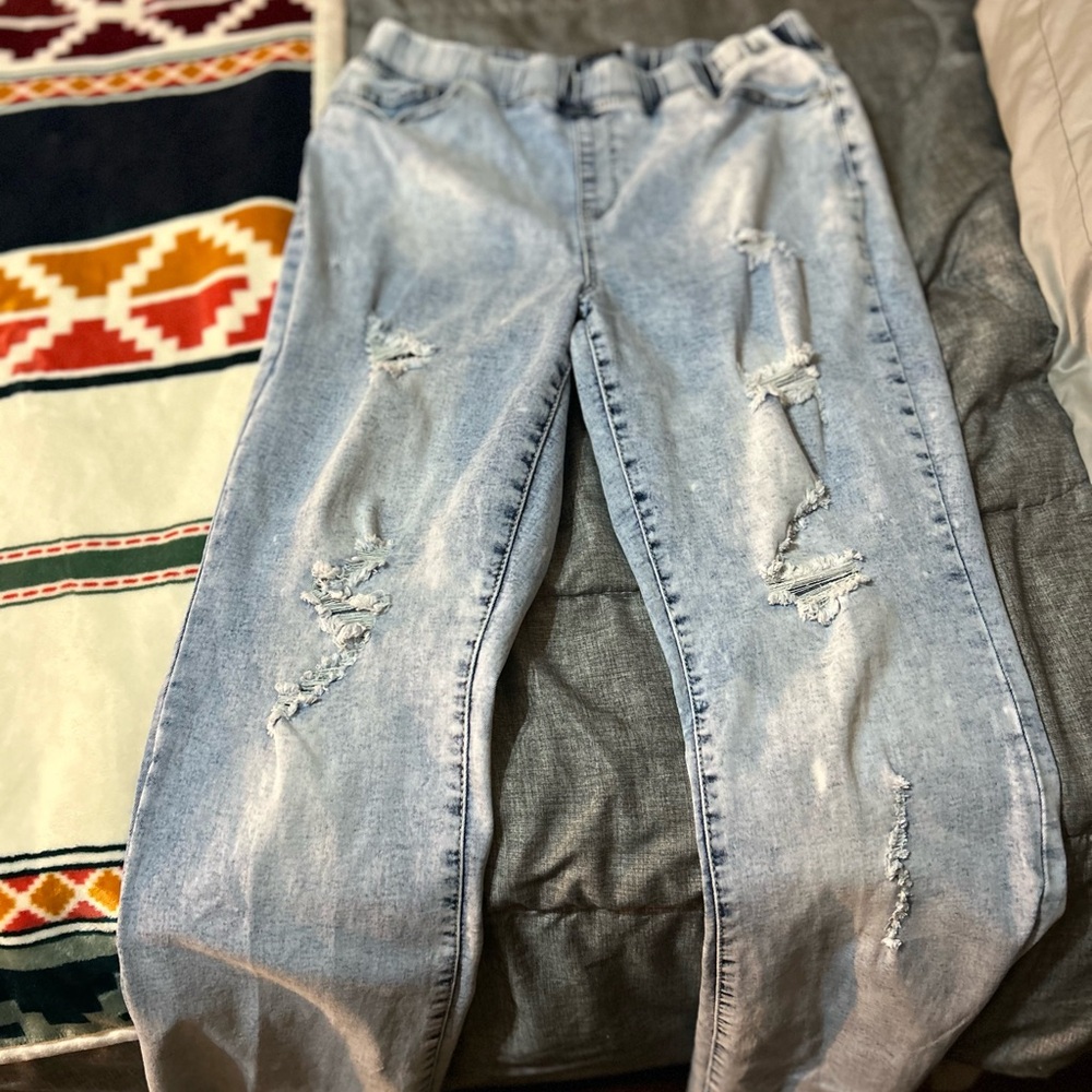 Ripped light blue jean big leg women’s pants.
